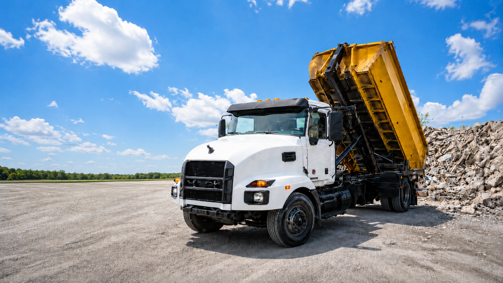 Goldmine Dumpsters roll-off truck at sunset